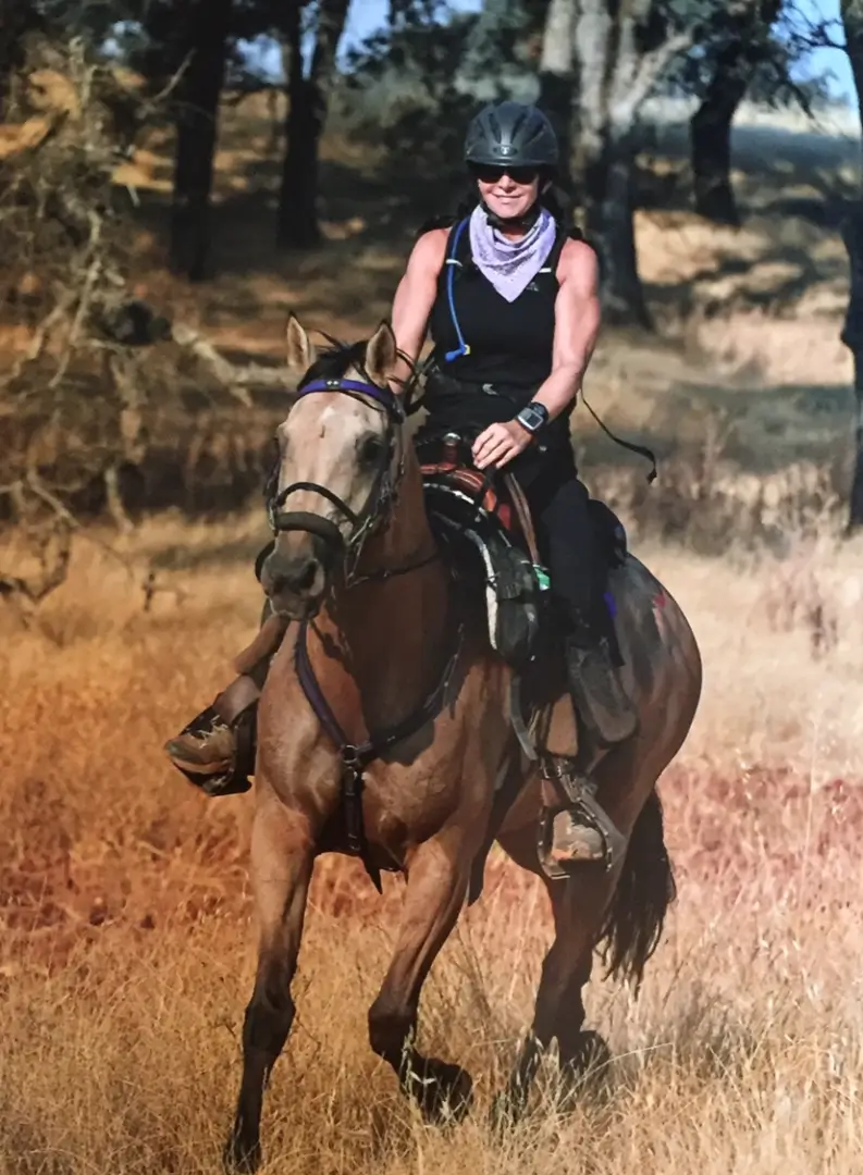 A woman riding on the back of a horse.